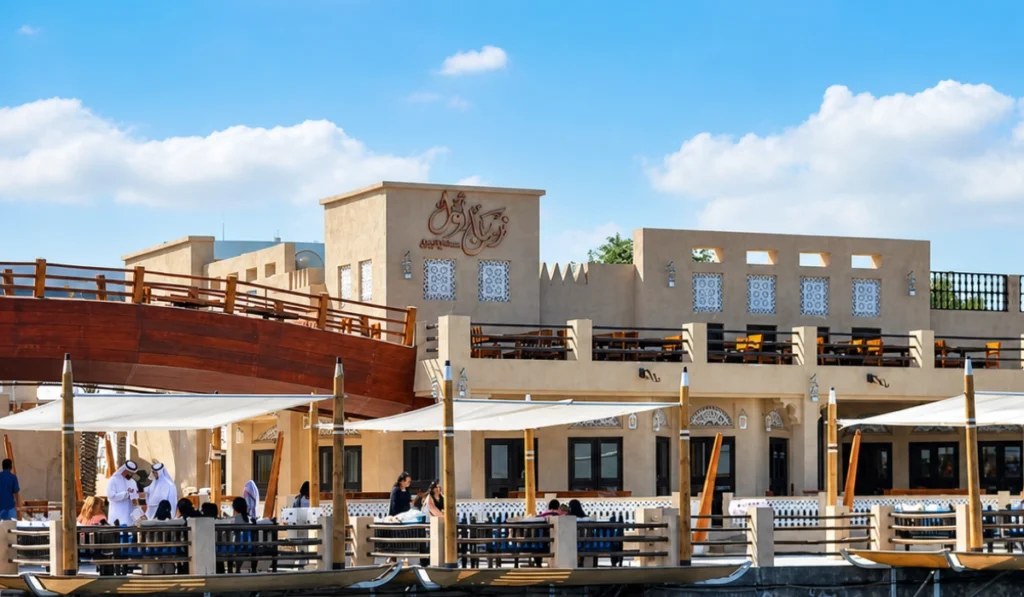 Al Boom Tourist Village Dubai waterfront restaurant with traditional Arabian architecture and creekside dining
