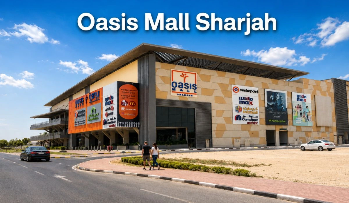 Oasis Mall Sharjah main entrance with parking area, cars, and visitors walking outside